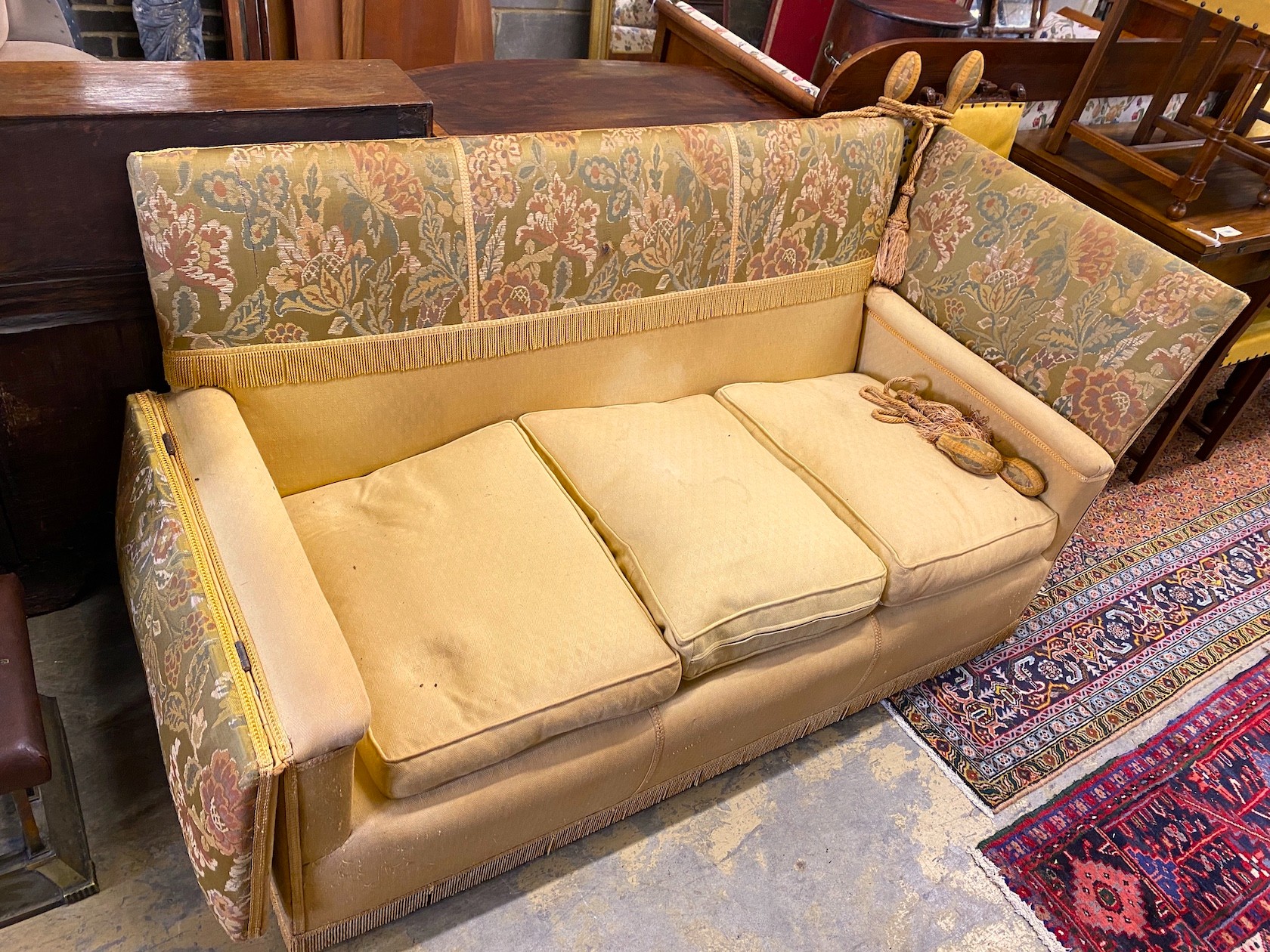 A Knole settee, upholstered in floral brocade, width 186cm, depth 80cm, height 104cm.